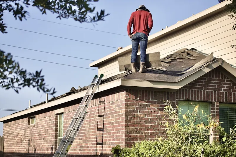 Professional roofer working on a residential roof in Layhill